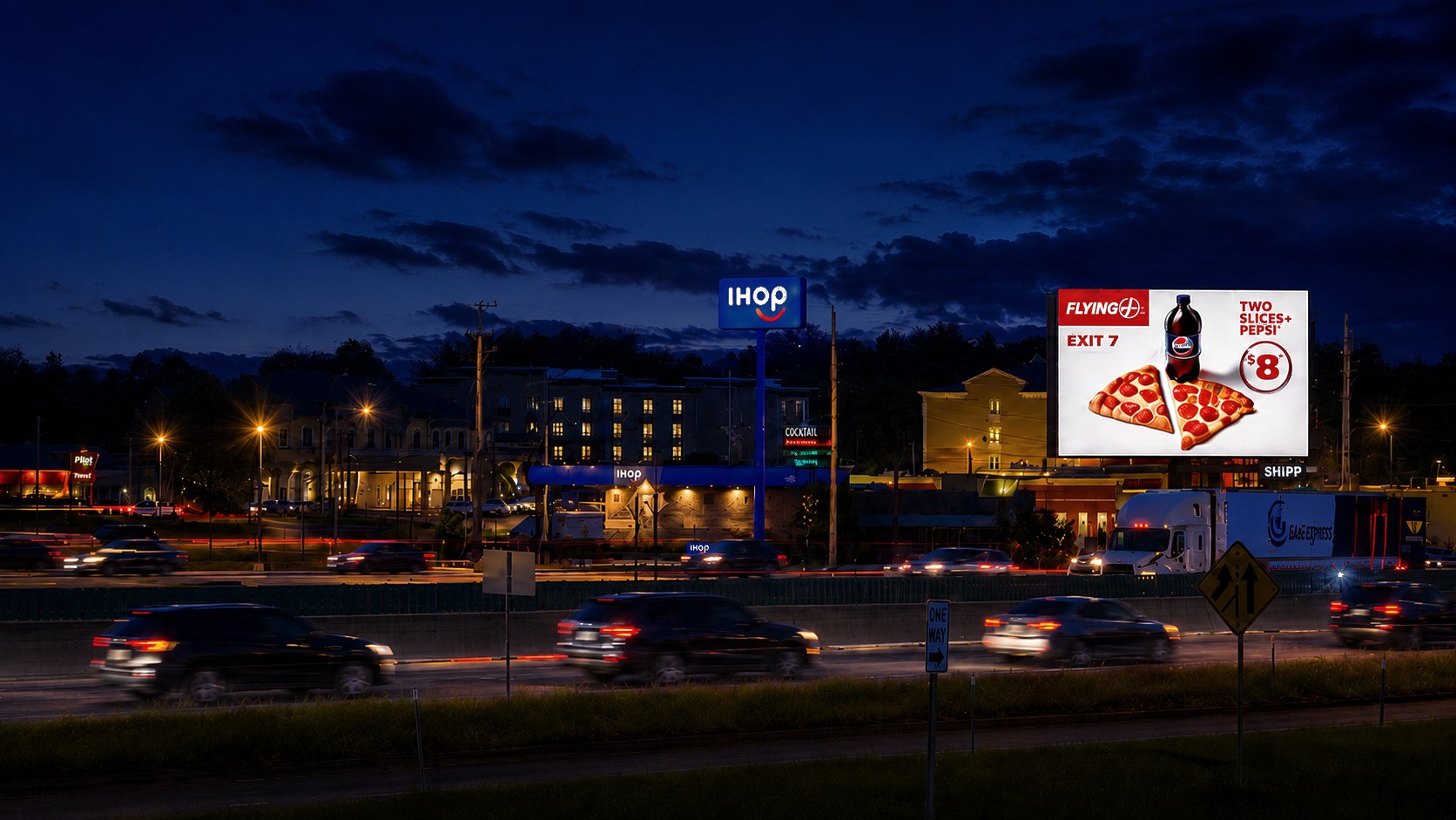 Shipp Outdoor static billboard lit at night over the interstate